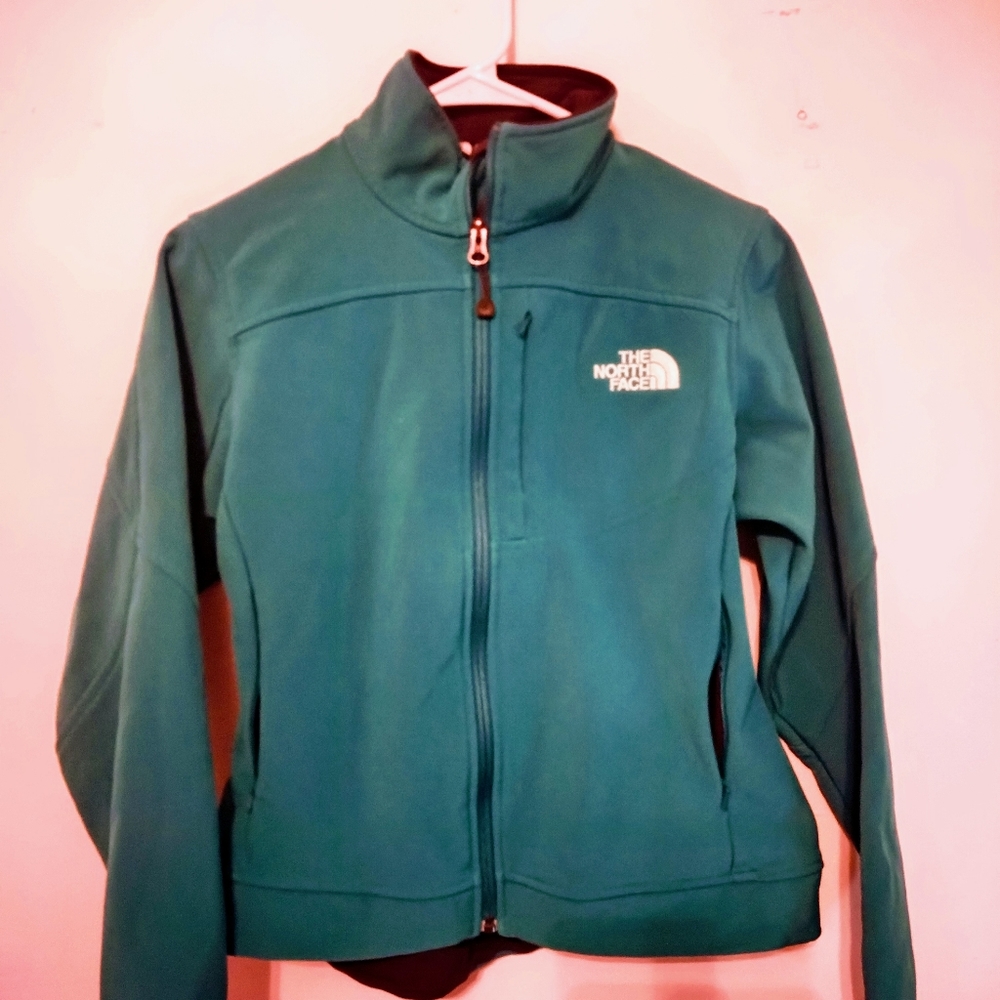 The North Face jacket torquise size small. 100% polyester warm and fuzzy inside